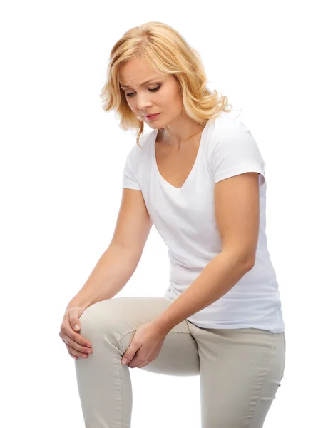 Mulher infeliz que sofre de dor na perna em casa — Fotografia de Stock