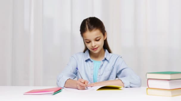 School girl writing math task to notepad — Stock Video