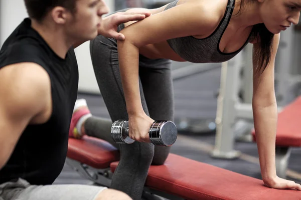 Close up of couple with dumbbell exercising in gym — Stock Photo, Image