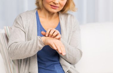 close up of woman suffering from hand inch at home clipart