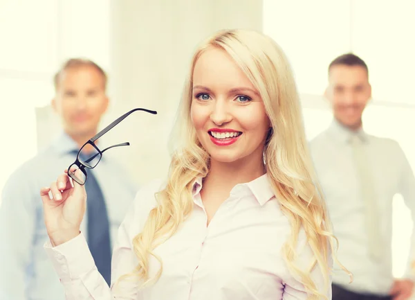 Smiling businesswoman or secretary in office — Stock Photo, Image