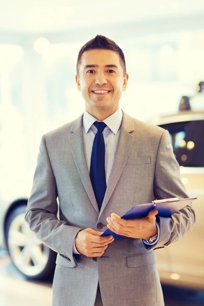 Happy man at auto show or car salon — Stock Photo, Image