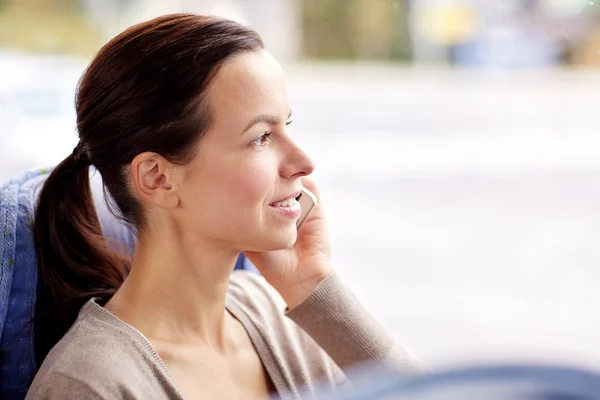 Happy woman in travel bus calling on smartphone — Stock Photo, Image