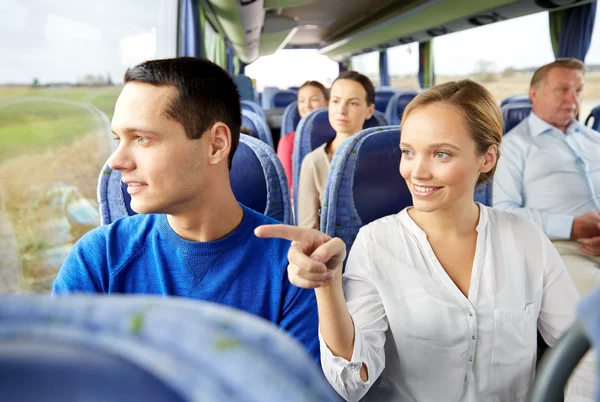 Happy couple or passengers in travel bus — Stock Photo, Image