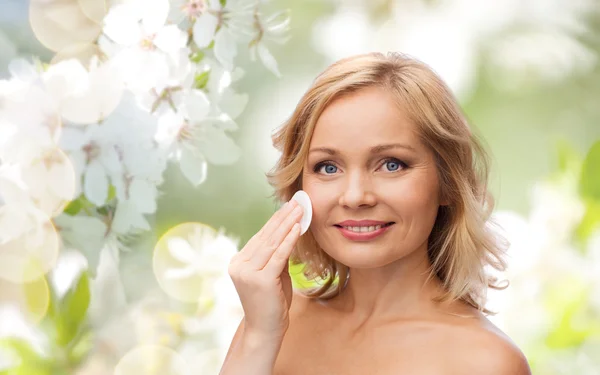 Mulher feliz limpeza rosto com almofada de algodão — Fotografia de Stock