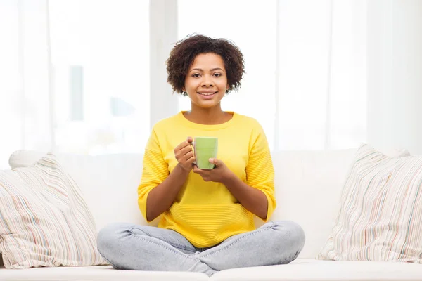 Happy african american woman drinking from tea cup — Stock Photo, Image