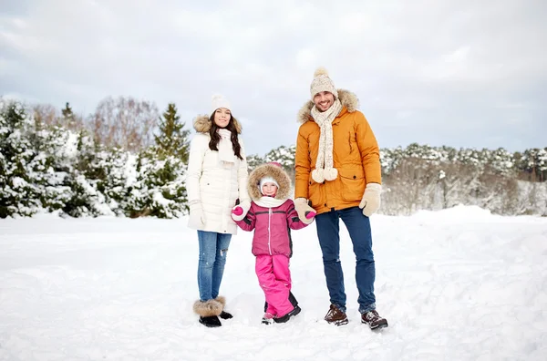 Happy family with child in winter clothes outdoors — Stock Photo, Image