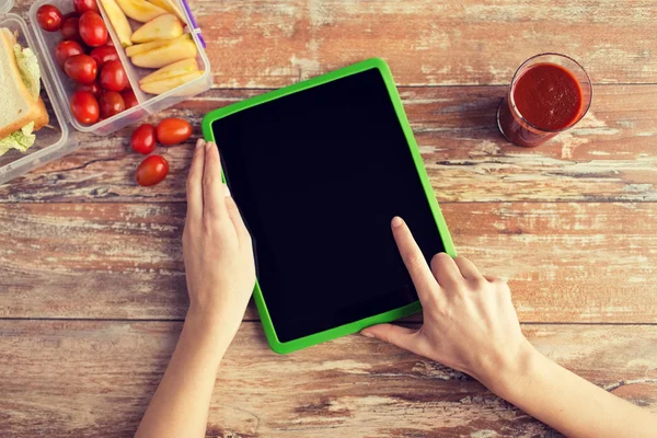 Close up of woman with tablet pc food on table — Stock Photo, Image