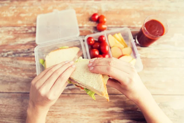 Close up of woman with food in plastic container — Stock Photo, Image