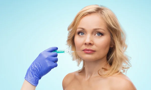 Woman face and beautician hand with syringe — Φωτογραφία Αρχείου