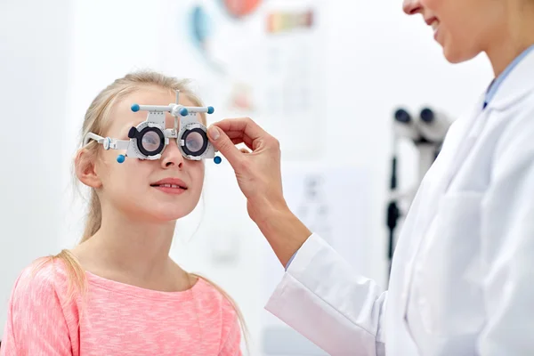 Opticien met proef frame en meisje bij kliniek — Stockfoto