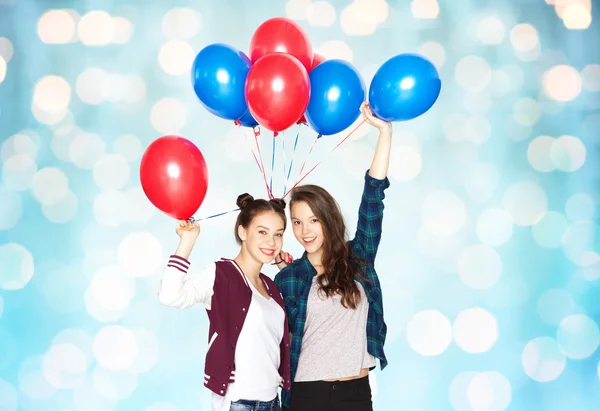 Happy teenage girls with helium balloons — Stock Photo, Image