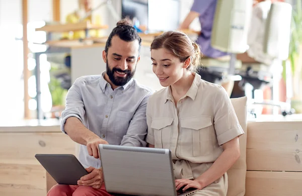 Creative team with tablet pc and laptop in office — Stock Photo, Image