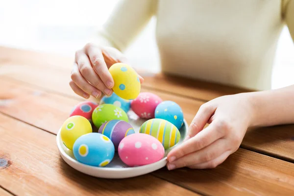 Primo piano di mani di donna con uova di Pasqua colorate — Foto Stock