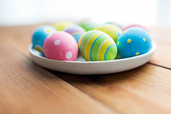 Close up of colored easter eggs on plate — Stock Photo, Image