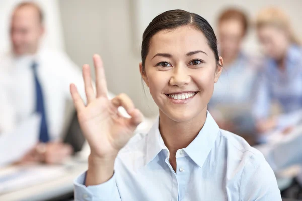 Group of smiling businesspeople meeting in office — Stock Photo, Image