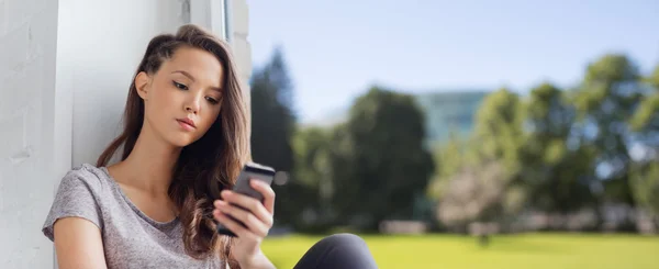 Triste bonita adolescente com mensagens de texto smartphone — Fotografia de Stock