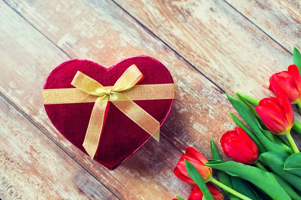 Close up of red tulips and chocolate box — Stock Photo, Image
