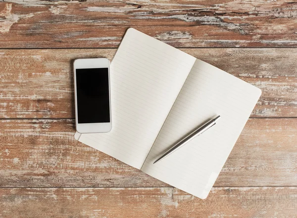 Close up of notebook, pen and smartphone — Stock Photo, Image