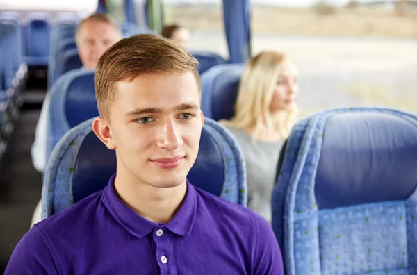 Happy young man sitting in travel bus or train — Stock Photo, Image