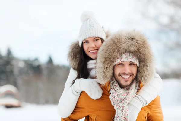 Happy couple having fun over winter background — Stock Photo, Image