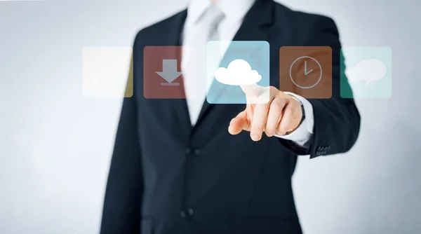 Close up of man pointing finger to cloud icon — Stock Photo, Image