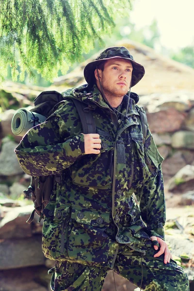 Young soldier with backpack in forest — Stock Photo, Image