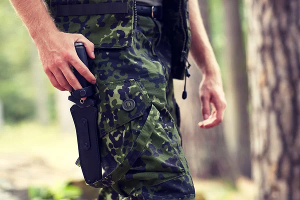 Close up of soldier or hunter with knife in forest — Stock Photo, Image