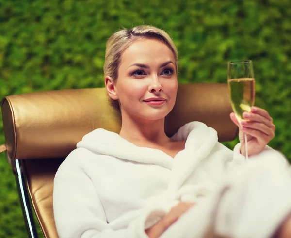 Beautiful young woman drinking champagne at spa — Stock Photo, Image