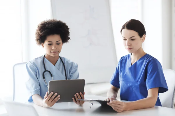 Médicos com tablet pc reunião no hospital — Fotografia de Stock