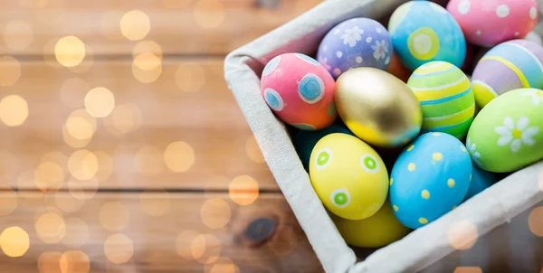 Close up of colored easter eggs in basket — Stock Photo, Image