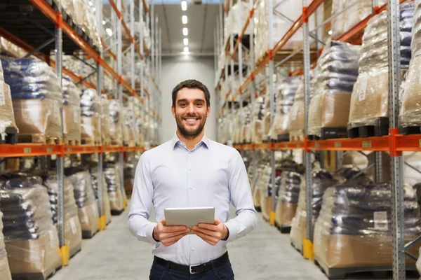Happy businessman with tablet pc at warehouse — Stock Photo, Image