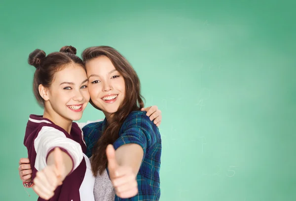 Happy teenage student girls showing thumbs up — Φωτογραφία Αρχείου