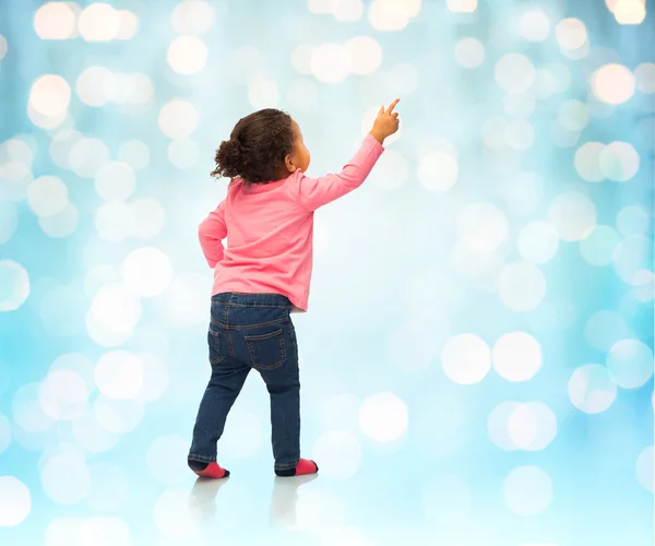 African baby girl pointing finger to something — Stock Photo, Image