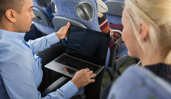 Close up of passengers with laptop in travel bus — Stock Photo, Image