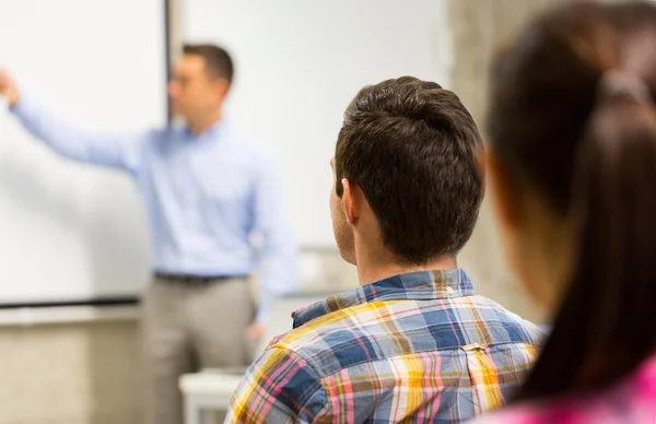 Group of students and teacher in classroom — Stock Photo, Image