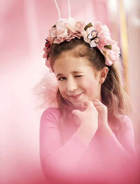 Adorable cute girl with a colorful chaplet — Stock Photo, Image