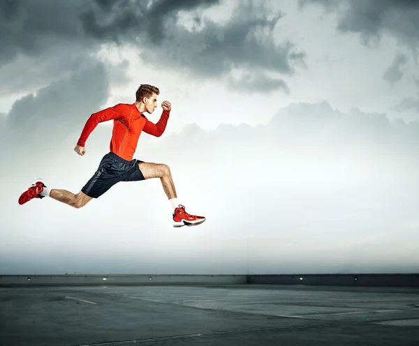 Young handsome athlete running — Stock Photo, Image