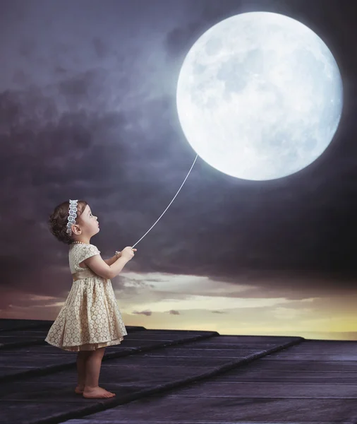 Fairy portait of a little girl with a moony balloon — Stock Photo, Image