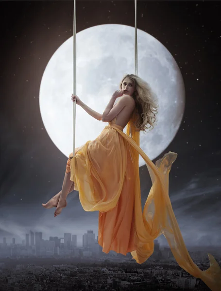 Elegant woman over big moon background — Stock Photo, Image