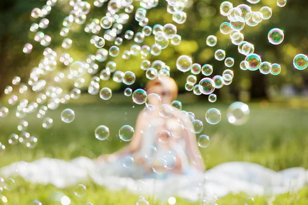 Mother and daughter family time, blowing soap-bubbles Stock Photo