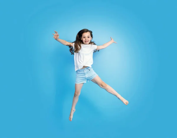 Portrait Cute Cheerful Jumping Little Girl Stock Photo