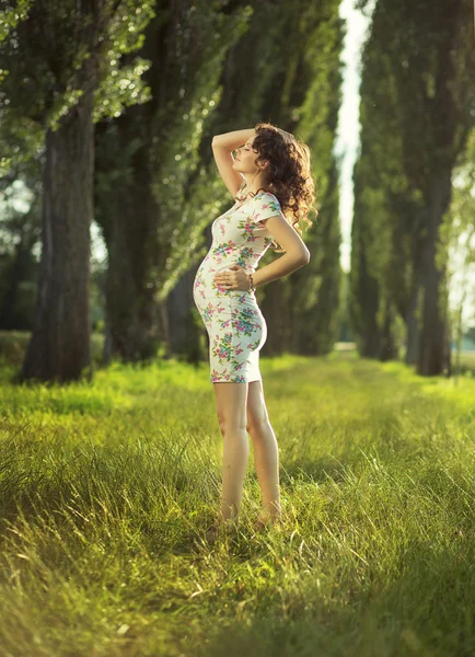 Portrait of the pregnant woman in the park Royalty Free Stock Images
