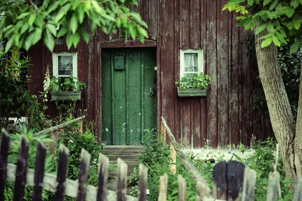 Vieille maison avec une porte verte profonde — Photo