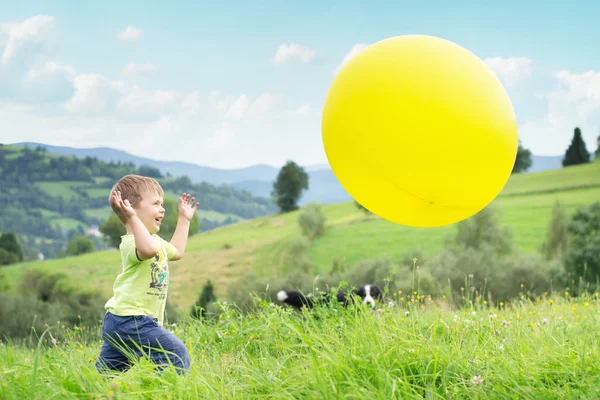 爱笑的男孩追逐气球 — 图库照片