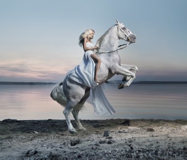 Amazing portrait of blond woman on the horse clipart