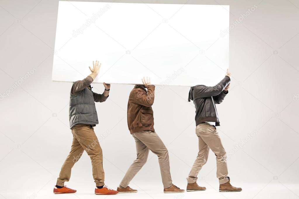 Conceptual picture of three guys carrying the board