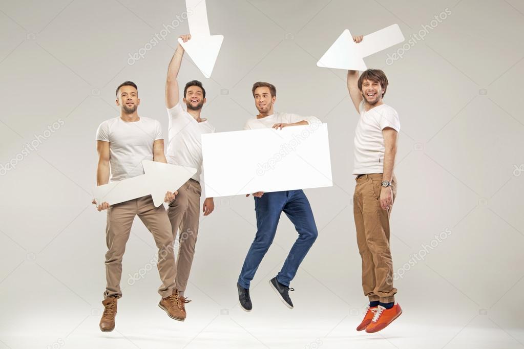 Handsome students jumping with symbols