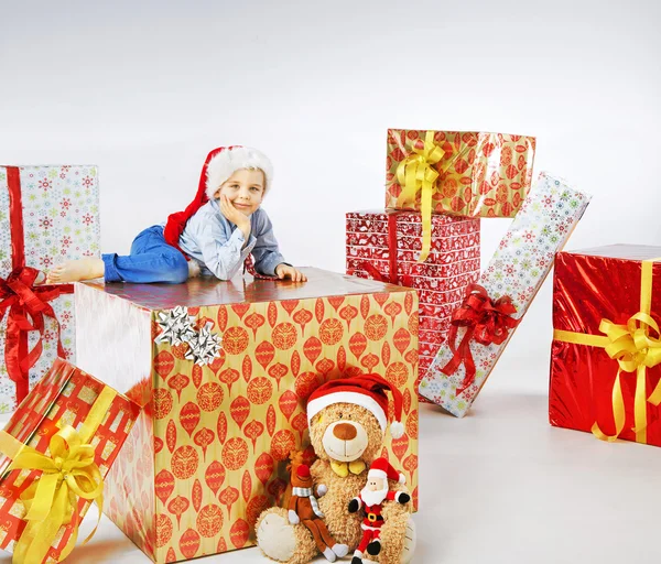 Charming little boy among the gifts — Stock Photo, Image