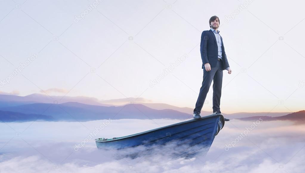 Young handsome man on wooden boat